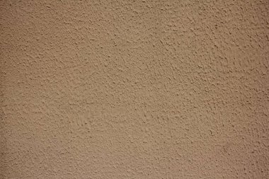 Arka plan desenli eski kahverengi alçılı beton duvar.