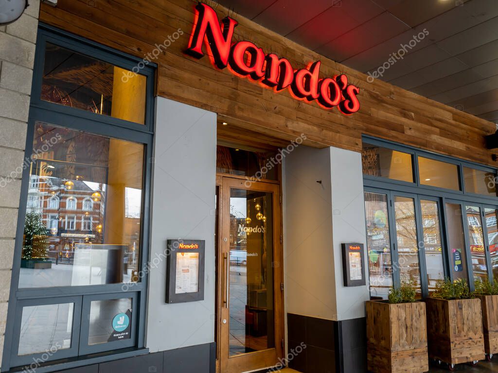 London. UK- 11.28.2021. A branch of the restaurant chain Nando's showing the company logo and trademark.