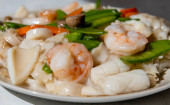 A dish of stir fried seafood with rice pasta or Ho Fun with sauce.