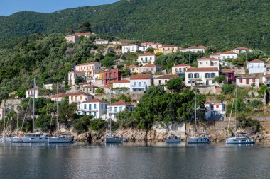Ithaca Island, Greece-05.25.2022. A general view of the seafront of Kioni with its apartments restaurants and shops to cater for holiday makers. clipart