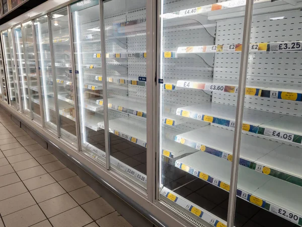 Interior of a grocery store with empty shelves. Food shortage, crisis.