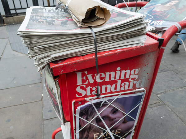 London. UK- 09.15.2022. A Evening Standard newspaper stand by the entrance of a London Underground station offering free copies to evening commuters.