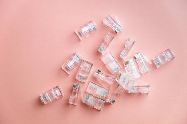 Transparent ethernet internet RJ-45 connectors, tehnology background on pink. LAN connectors plug.