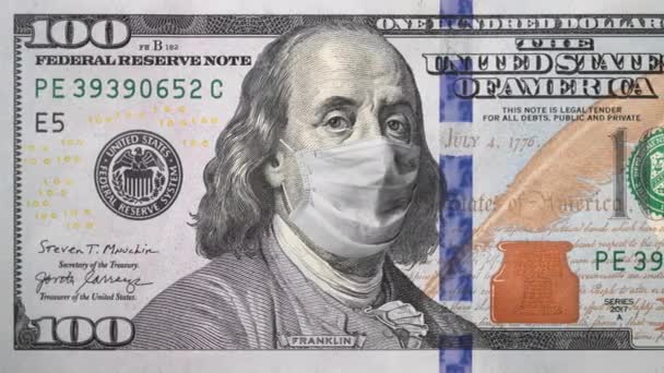 Ένα χαρτονόμισμα των 100 δολαρίων με προστατευτική μάσκα προσώπου στο πορτραίτο του Μπέντζαμιν Φράνκλιν. Οικονομική κρίση κατά την έννοια της πανδημίας Covid-19. Τραπεζογραμμάτιο 100 δολαρίων. 4k υψηλής ποιότητας πλάνα — Αρχείο Βίντεο