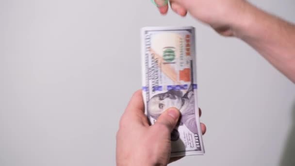 Honderd dollar in een medisch masker. De wereldeconomie tijdens de COVID-1 pandemie. Hoge kwaliteit 4k beeldmateriaal — Stockvideo