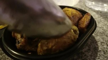 Kapalı çekimde siyah plastik bir kapta ızgara tavuk servis ediyorum. Teslimatla getiriliyor ve gece 4 km 'de mutfakta arkadaşlara servis ediliyor.