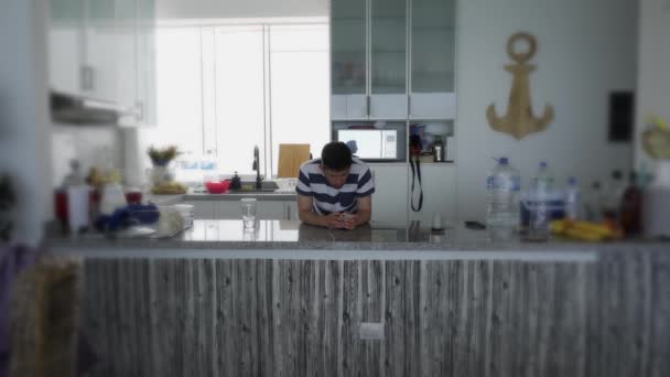 Man Looking His Cell Phone Kitchen While Waiting Food Boil — Vídeo de stock