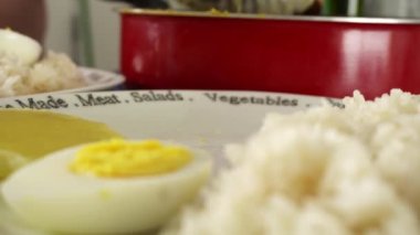 Tabaklara pilav ile ji de pollo, mutfakta patatesle haşlanmış yumurta servis etmek, tipik Peru yemeği.