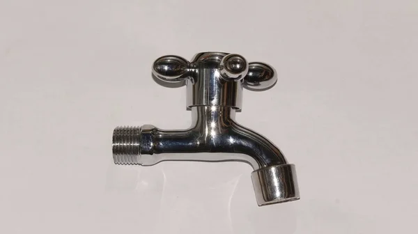 Su musluğu beyaz arka planda izole edilmiş. Genellikle banyo, bahçe ve lavaboda kullanılır.