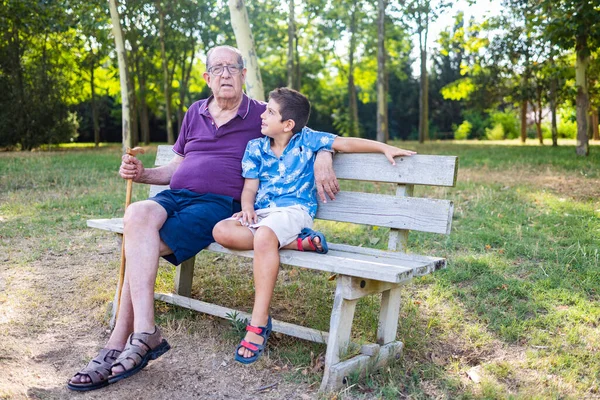 Παππούς Και Εγγονός Του Κάθονται Ένα Παγκάκι Στο Πάρκο — Φωτογραφία Αρχείου