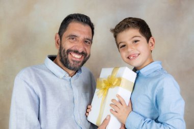 Küçük çocuk Babalar Günü 'nde babasına hediye veriyor.