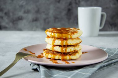Kızarmış süzme peynirli krep ve kaynamış karamel. Lezzetli sağlıklı yiyecekler. Akşam yemeği, yakın plan.