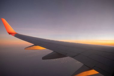 Sky, cloud during the sunrise from window of airplane.