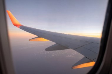 Sky, cloud during the sunrise from window of airplane.