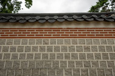 Traditional Korean stone wall boundary with roof