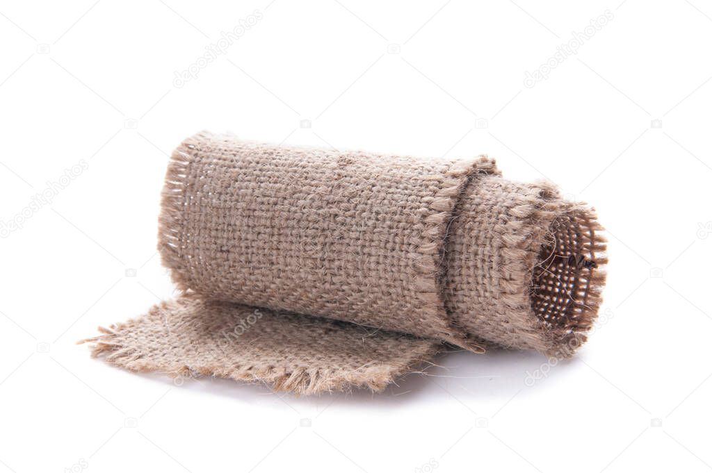 A piece of burlap tape rolled up. side view