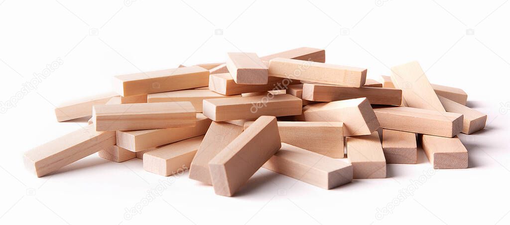 Heap of wooden blocks tower game isolated on white