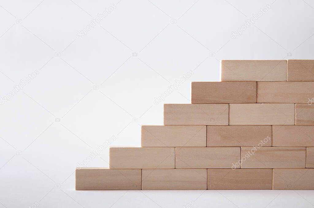 Wooden block steps on a gray background. Wall. Concept. Rise up. Height. Promotion. ladder. Stairs.