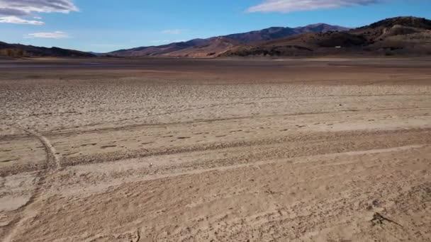 Aerial pull back of dry lake bed in the arid western United States — Stock Video