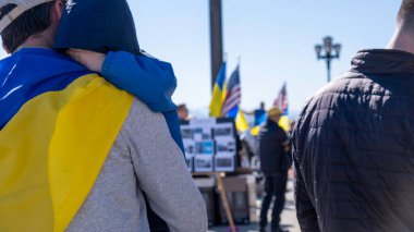 Babam Ukrayna bayrağı takıyor ve çocuğu Ukrayna rallisinde tutuyor.