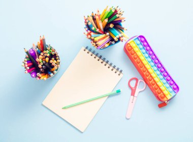 Trendy back to school composition with colorful school supplies. Flat lay, space for copy space.