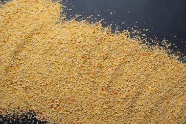 Tarhana, scattered tarhana isolated on black background, Turkish meal, soup ingredient concept idea photo, top view photo.