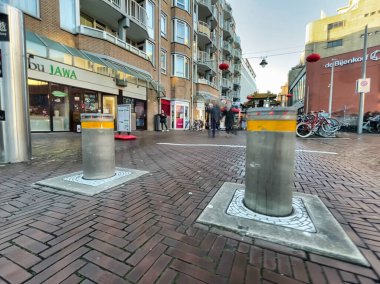 Den Haag, Netherlands - December 16 2021 : automatic bollards are used more and more on the street in dutch cities as security measure clipart