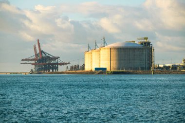 Rotterdam, Hollanda - 22 Kasım 2021: Limandaki gemi ve petrol tanklarının konteynırlarını boşaltmak için devasa yarıdan ve tamamen otomatik vinçlerden oluşan hatlar