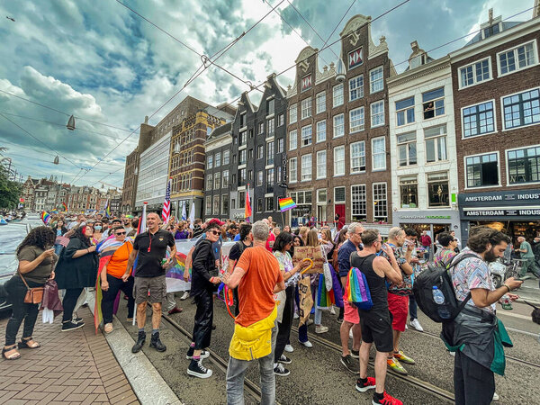 The Hague, Netherlands - 23 August 2021: many people participate to a pride walk in the center of historic amsterdam