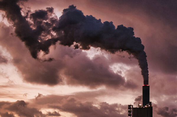 Rotterdam, Netherlands - November 22 2021 : a fume pipe of a petrochemical factory is sending a lot of co2 in to the atmospher