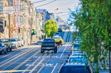 San Francisco, United States - October 10 2009 : driving cars up a hill in a street in san fancisco can be very difficult