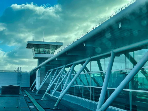 Schiphol, Netherlands - February 19 2022: a modern airport communication control tower on top of an airport terminal building