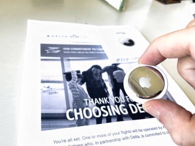 the hague, netherlands - august 11 2022: an airtag is shown which can track ones belongingings while linking to smartphones