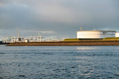Rotterdam, Hollanda - 22 Kasım 2021: Yeşil ve fosil enerji, rüzgar türbinleri ve fosil yakıtların bir kombinasyonu