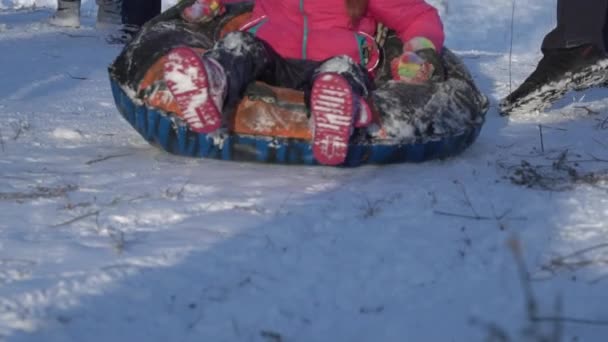 Children Sled on a Snow-covered Slide — Video Stock