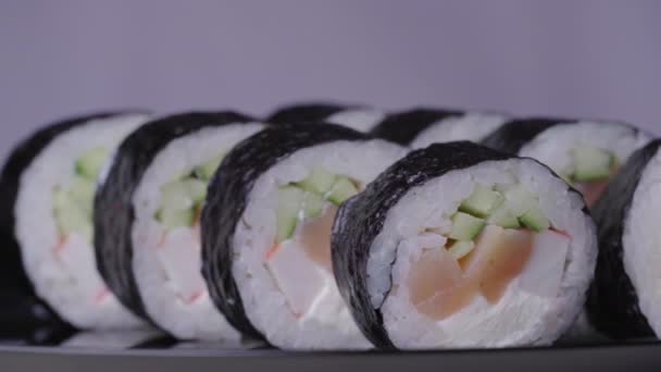 Sushi Roll Turned on a Pink Background — Stock Video