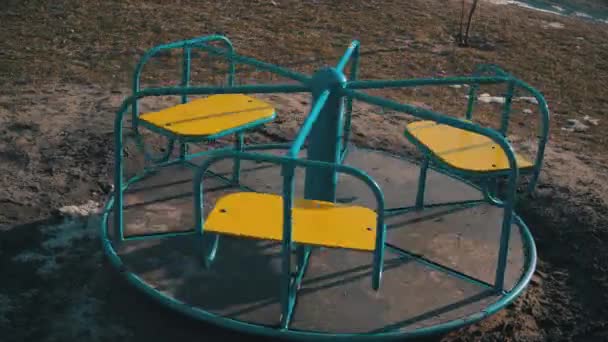 Empty Swing is Spinning on the Playground in the Yard — Stock Video