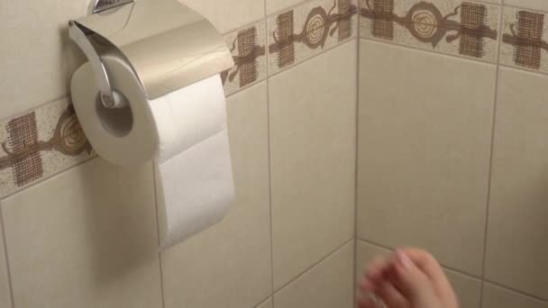 Frauenhand wickelt Toilettenpapier ab — Stockvideo