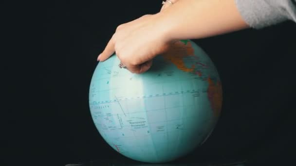 Geographical Globe is Twisted Around its Axis by a Female Hand — Stock Video