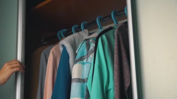 Girl Chooses Things in the Wardrobe at Home — Vídeo de Stock