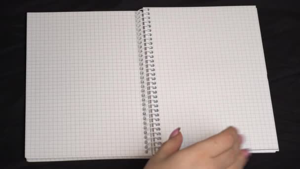 Girl Draws a Heart With a Pen in a Notebook