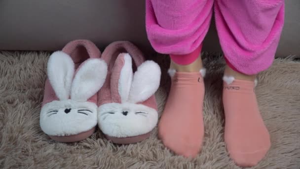 Young Woman Gets Out of Bed and Puts on Pink Slippers in the Morning — Stock Video