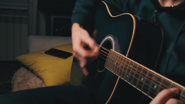 男は暗闇の中で現代のギターのピックを果たしています｜Slow Mo — ストック動画
