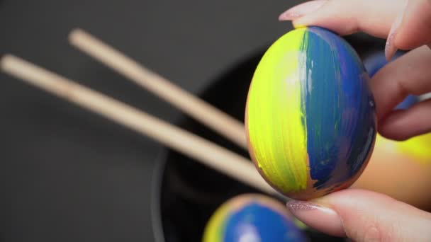 Girl Paints Easter Eggs in Yellow-Blue Color — Stock Video