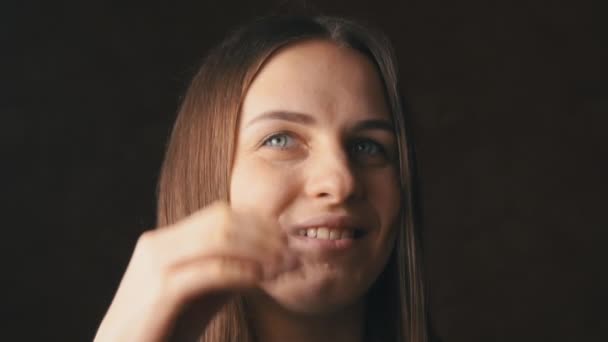 Face of a Beautiful Young Woman Straightening Her Hair Behind Her Ear — Stock Video