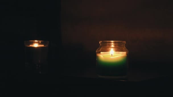 The Guy and the Girl Drink Wine by Candlelight in the Evening Near the Bed — Stock video