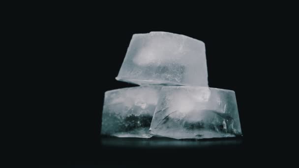 Square Ice Cubes are Spinning on a Black Background — Stock Video