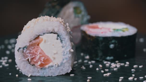 Friss sushi tekercs szezámmaggal készült speciális japán evőpálcikákkal. — Stock videók