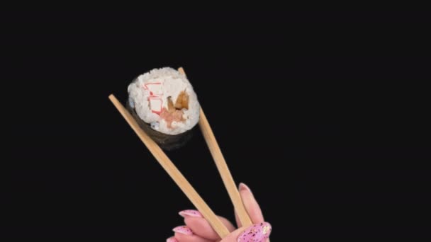 Female Hands Hold Japanese Chopsticks with Sushi Rolls on Transparent Background — ストック動画