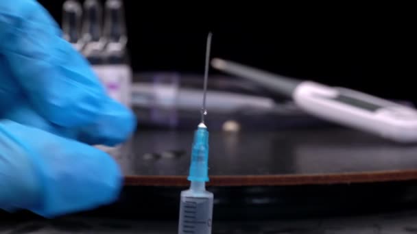 Nurse Prepares a Syringe And Medicine Drips from It in Large Drops Close-up — Video